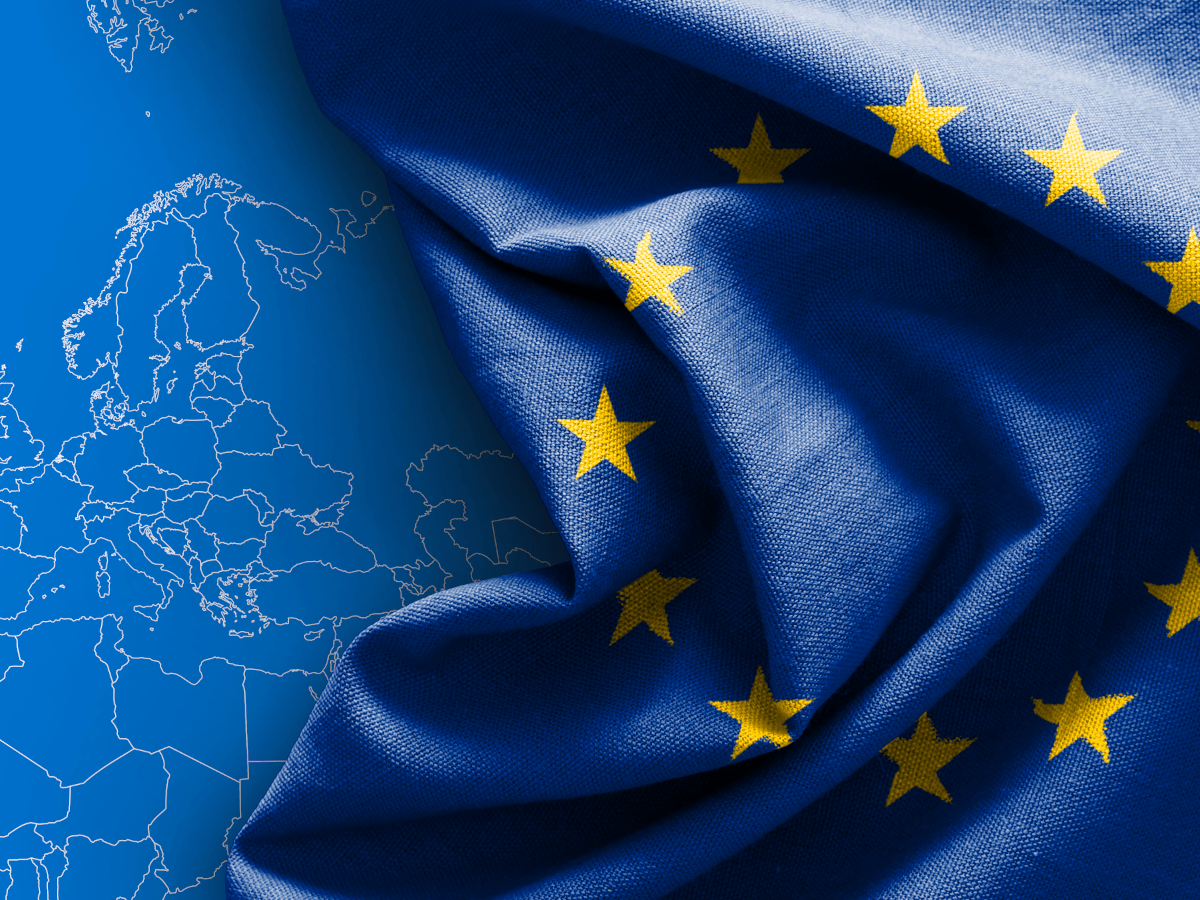 The EU flag over a blue map of part of Europe.