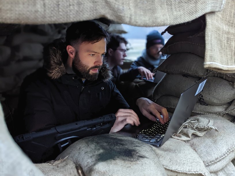 Man at laptop in a defense bunker