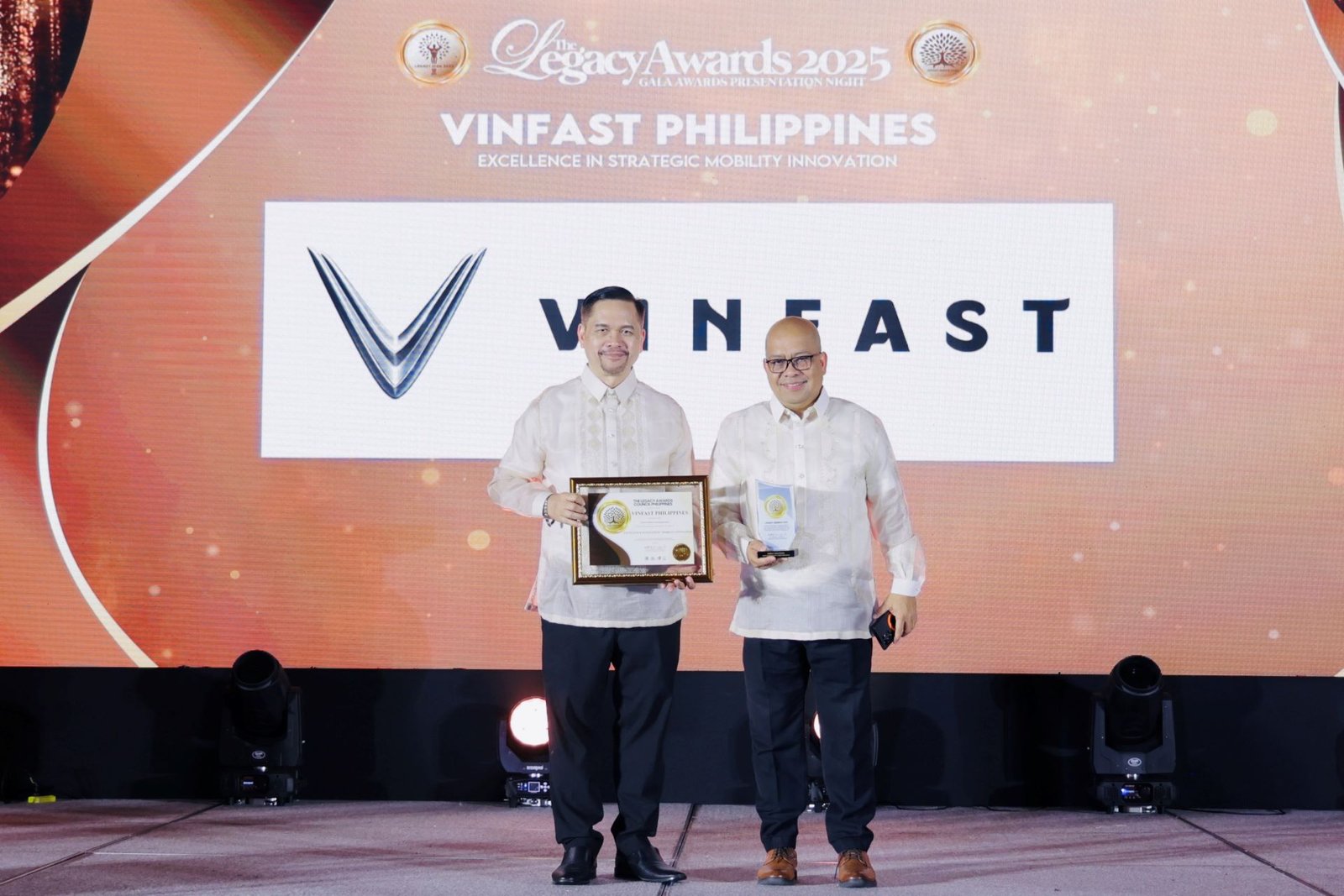 Mr. Abner Berdos, Deputy CEO of Sales and Dealer Network Development at VinFast Philippines (right) represented the company to receive the 2025 Legacy Awards for Business