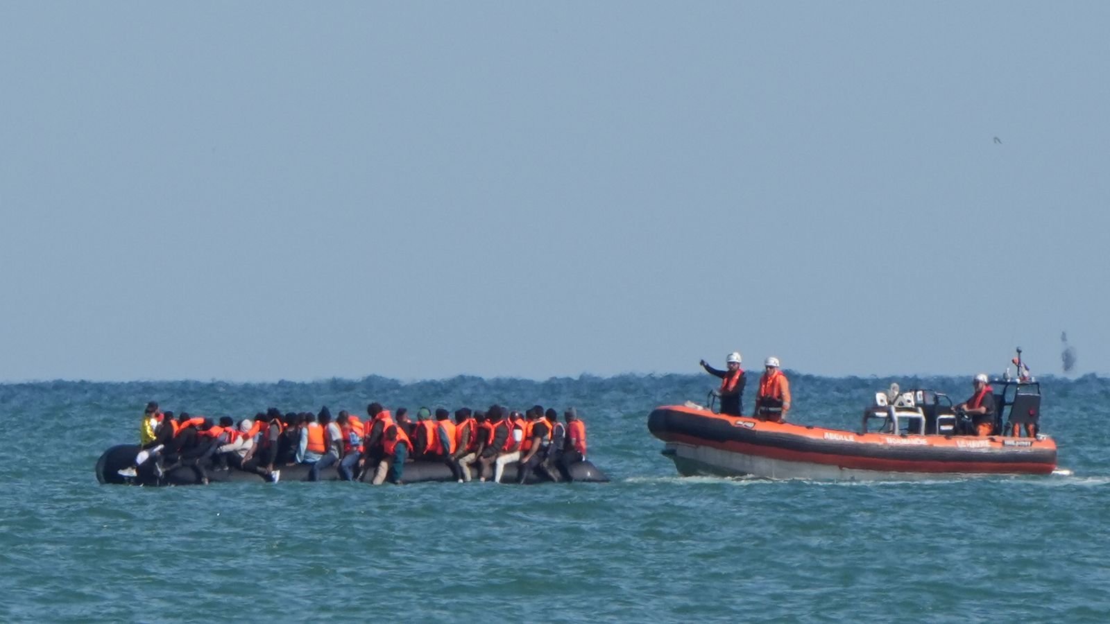 A boat intercepts migrants on a small boat in the Channel off Calais. File pic: PA