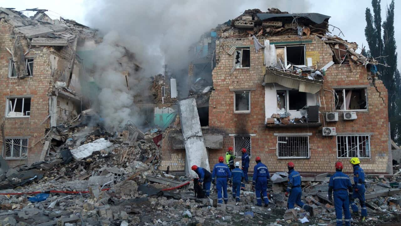 An apartment rubble is now reduced to rubble. Rescue crew can be seen moving around the site.