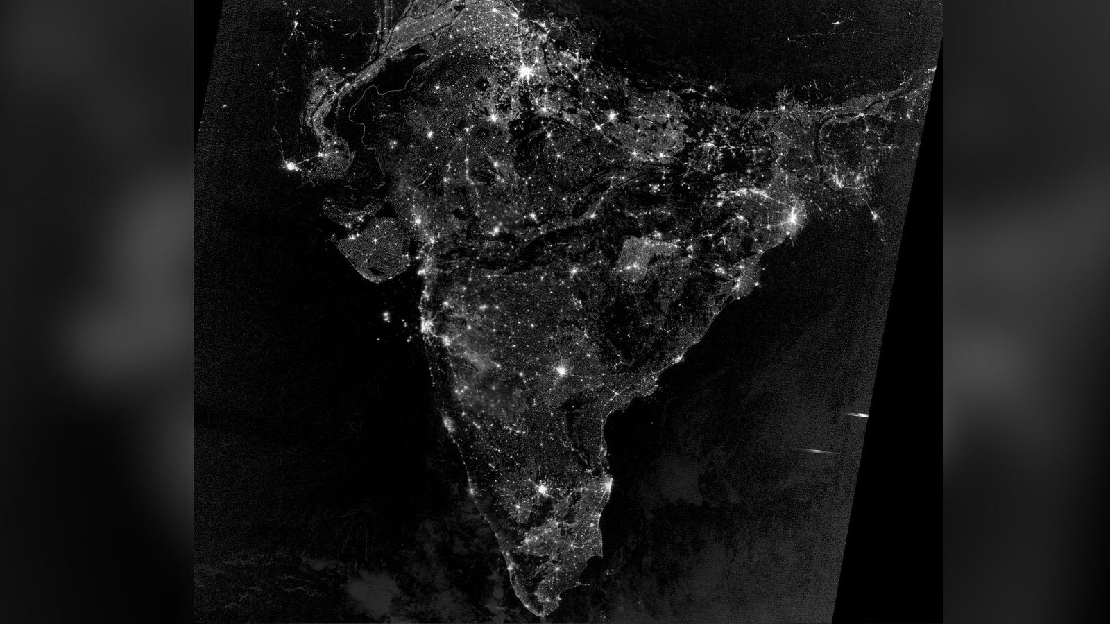 A black and white photo of India from space shows brilliant lights across the country for a Diwali celebration