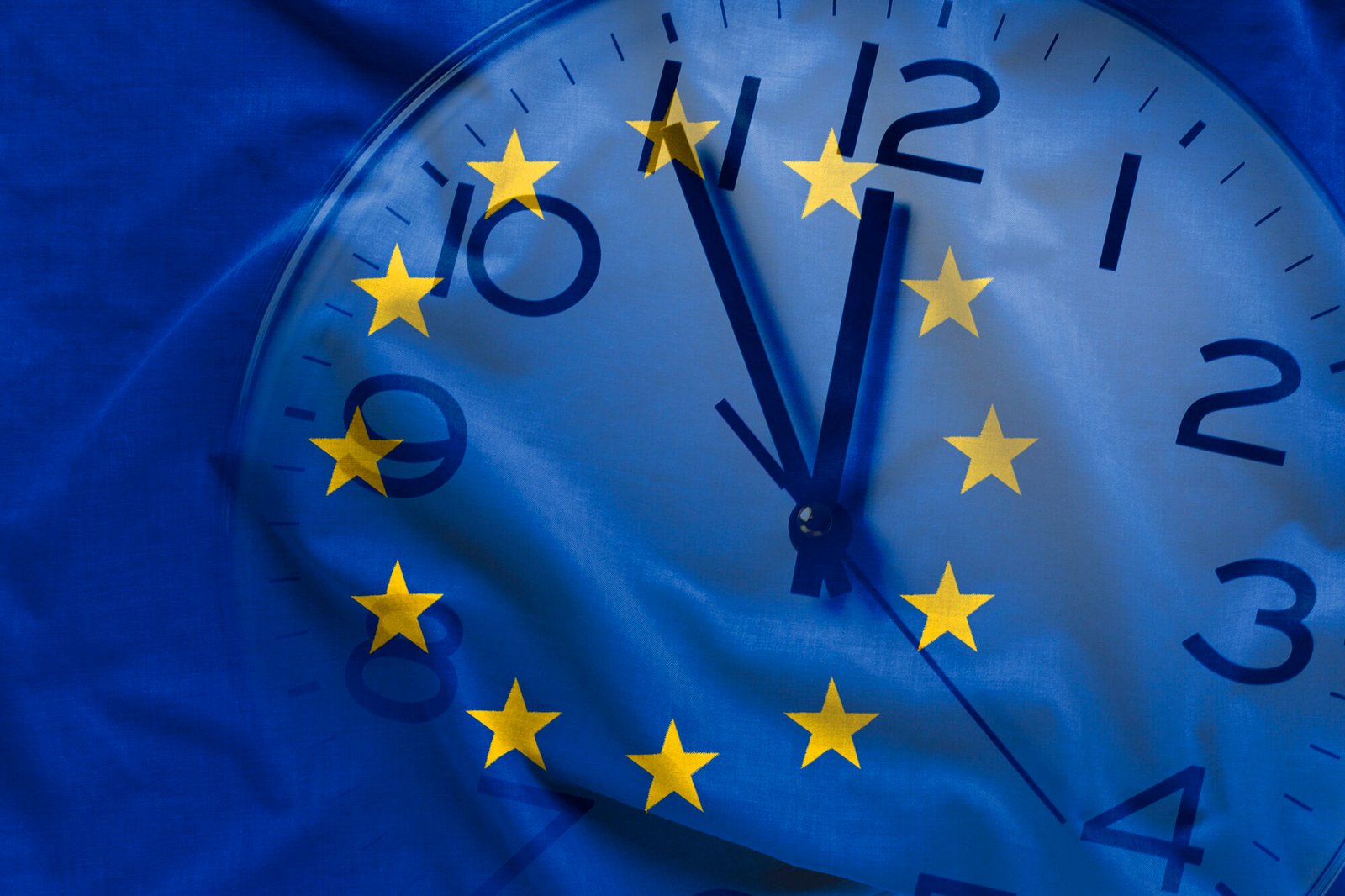 Double exposure of clock and blue flag of European Union