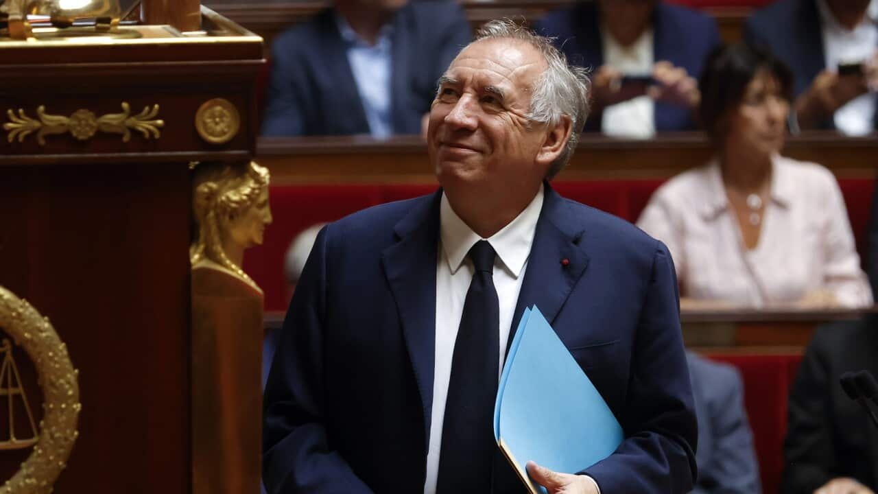 Prime Minister Francois Bayrou standing in France's Parliament