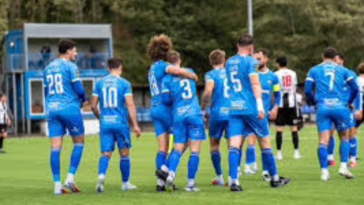 Haverfordwest County AFC soccer players in blue jerseys on the field during a Cymru Premier league match in Wales.