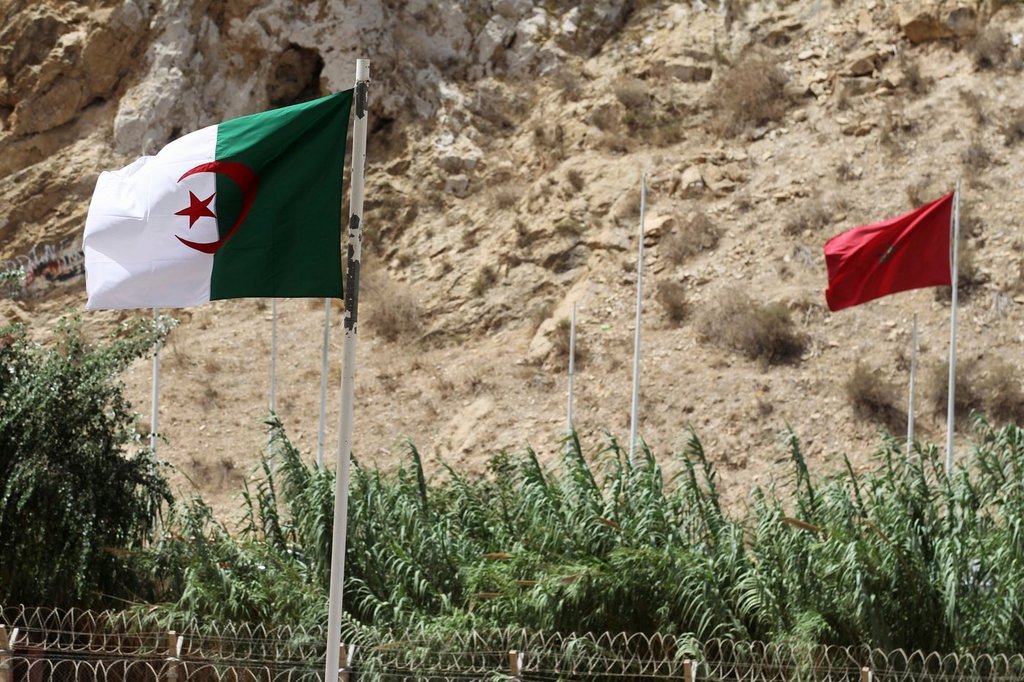 FILE - A view of Algerian and Moroccan flags along the closed border with Morocco, in the town of Marsa Ben M