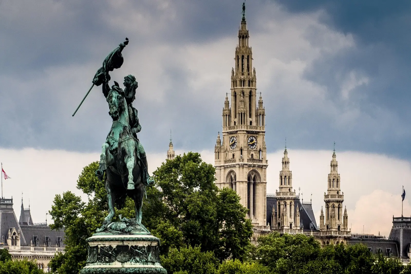 Statue of Archduke Charles and Vienna City Hall under stormy skies