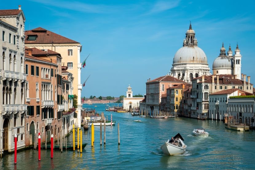 Venice offers a romantic and culturally rich experience with its canals, historical architecture, and festive events.