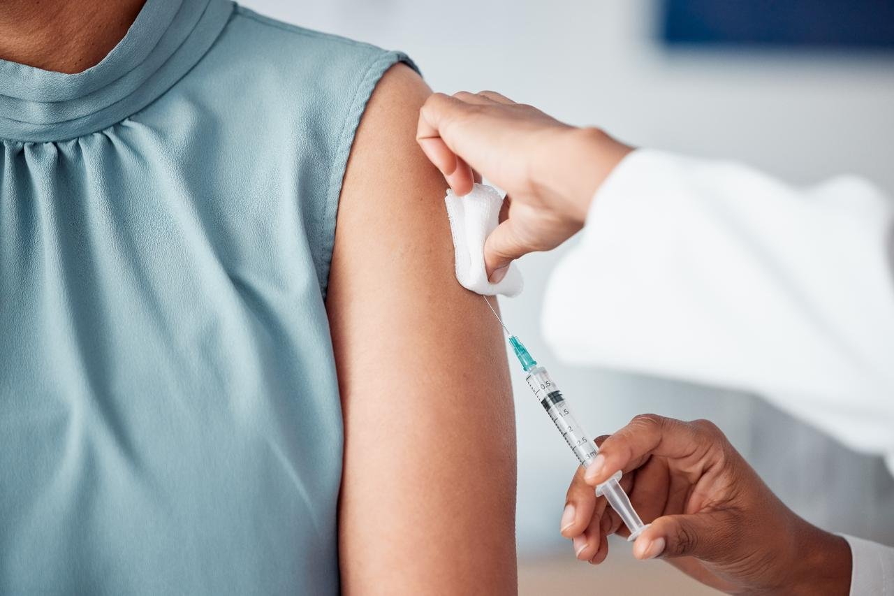 A doctor administers a vaccine to a patient. (Adobe Stock Photo)