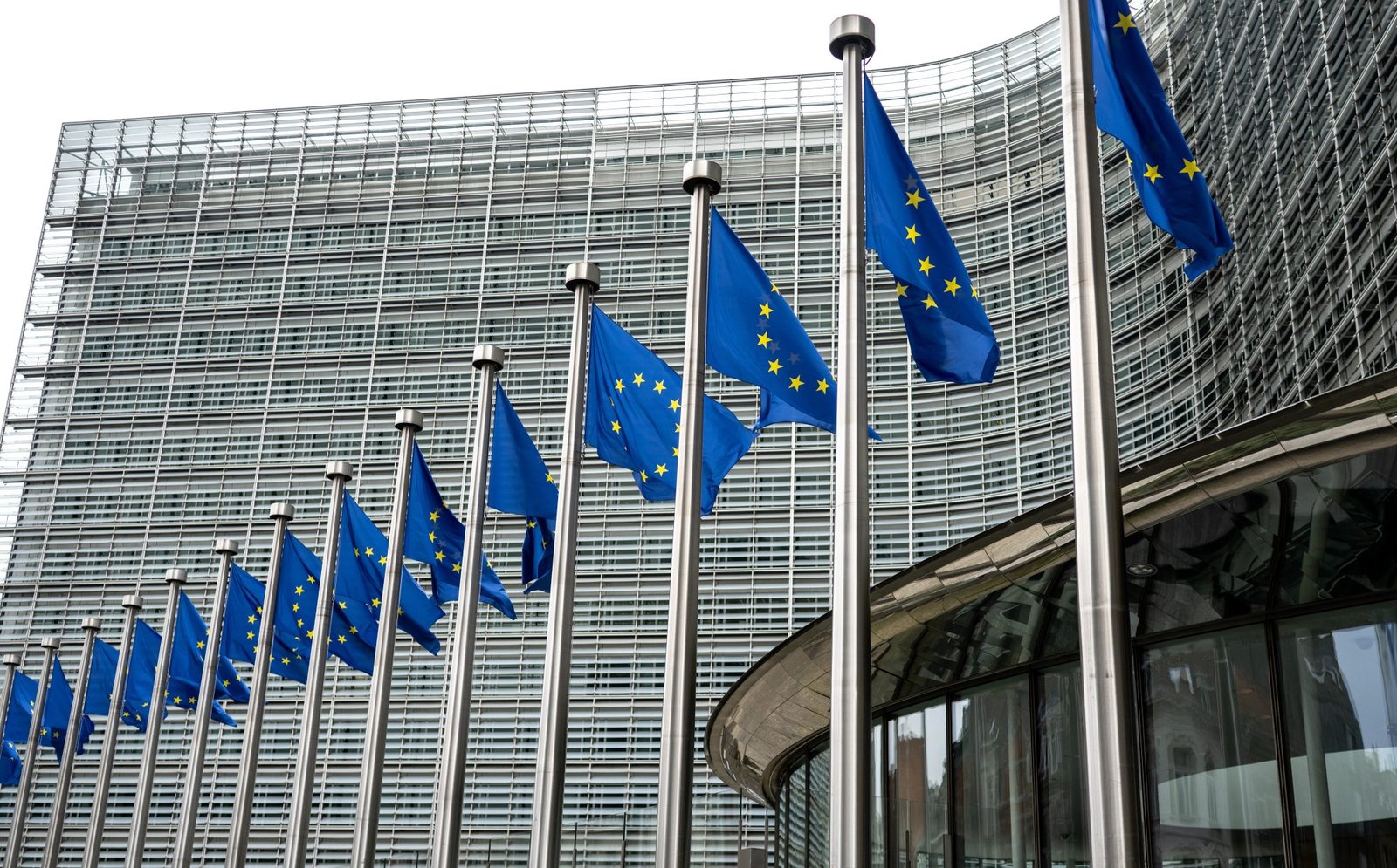 European Union Flags Waving In Brussels Opposite The European Commission Building