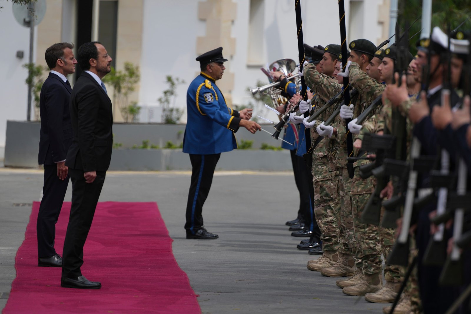 Cypriot President Nikos Christodoulides, foreground, and his French counterpart Emmanuel Macron stand for the national anthems at the presidential palace in Nicosia, Cyprus, Thursday, April 23, 2026. (AP Photo/Petros Karadjias)