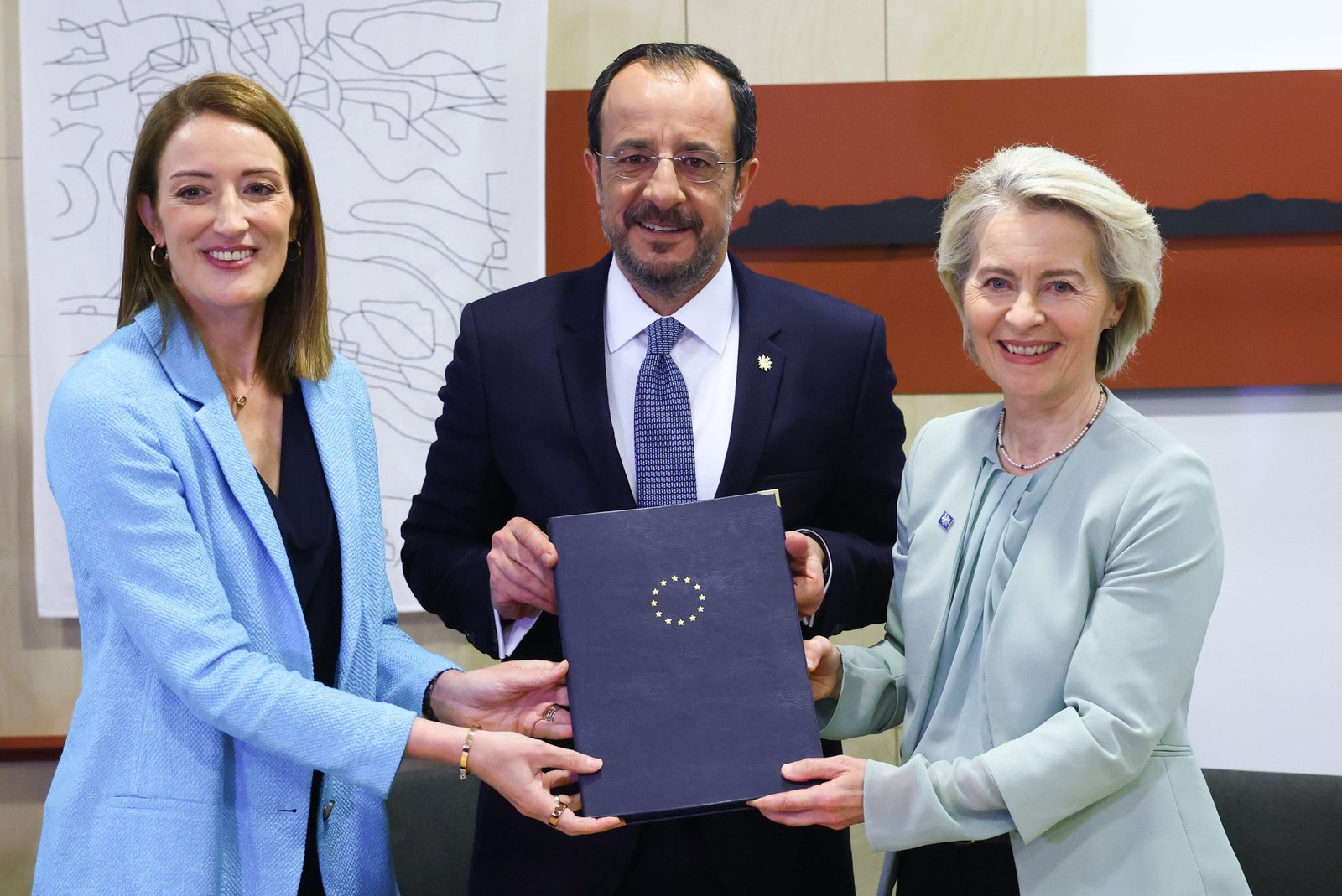 Cyprus President Nikos Christodoulides, center, European Parliament President Roberta Metsola, left, and European Commission President Ursula von der Leyen pose after signing the