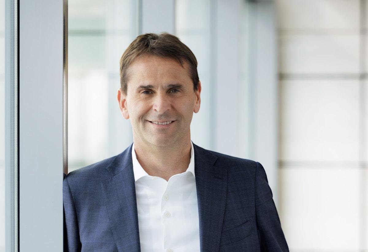 caucasian man in open short and blue suit jacket