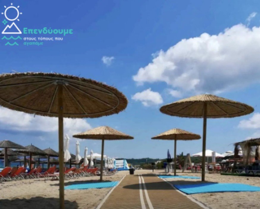 Accessible beach with shaded umbrellas and pathways for all visitors.