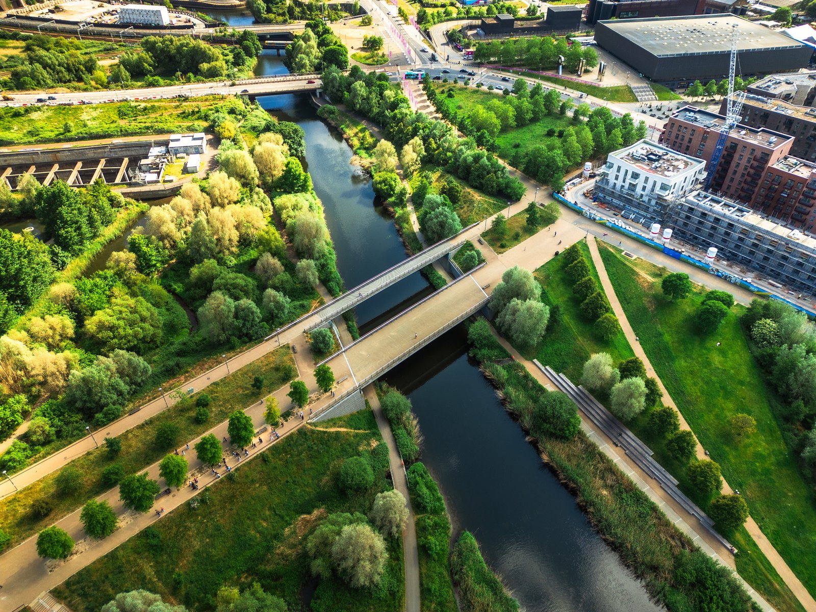 Aerial view, taken by drone, depicting the pathways and green lush foliage of the wetlands walk at Stratford in East London, alongside the River Lea.