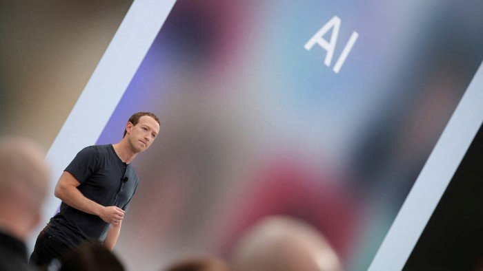 Mark Zuckerberg delivers a speech, as the letters AI for artificial intelligence appear on a screen
