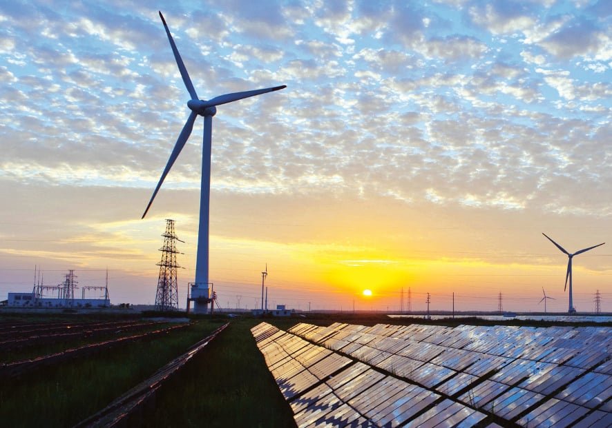 Solar PV panels and wind turbines at sunset