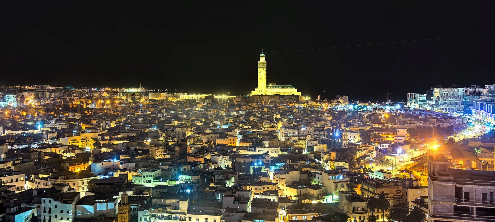 City scape at night dominated by large Hassan II mosque, Casablanca, stock exchange reforms boost economy