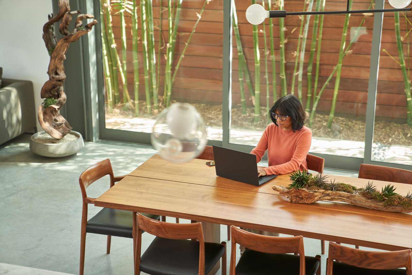 Overhead view of business decision maker working from home on a laptop