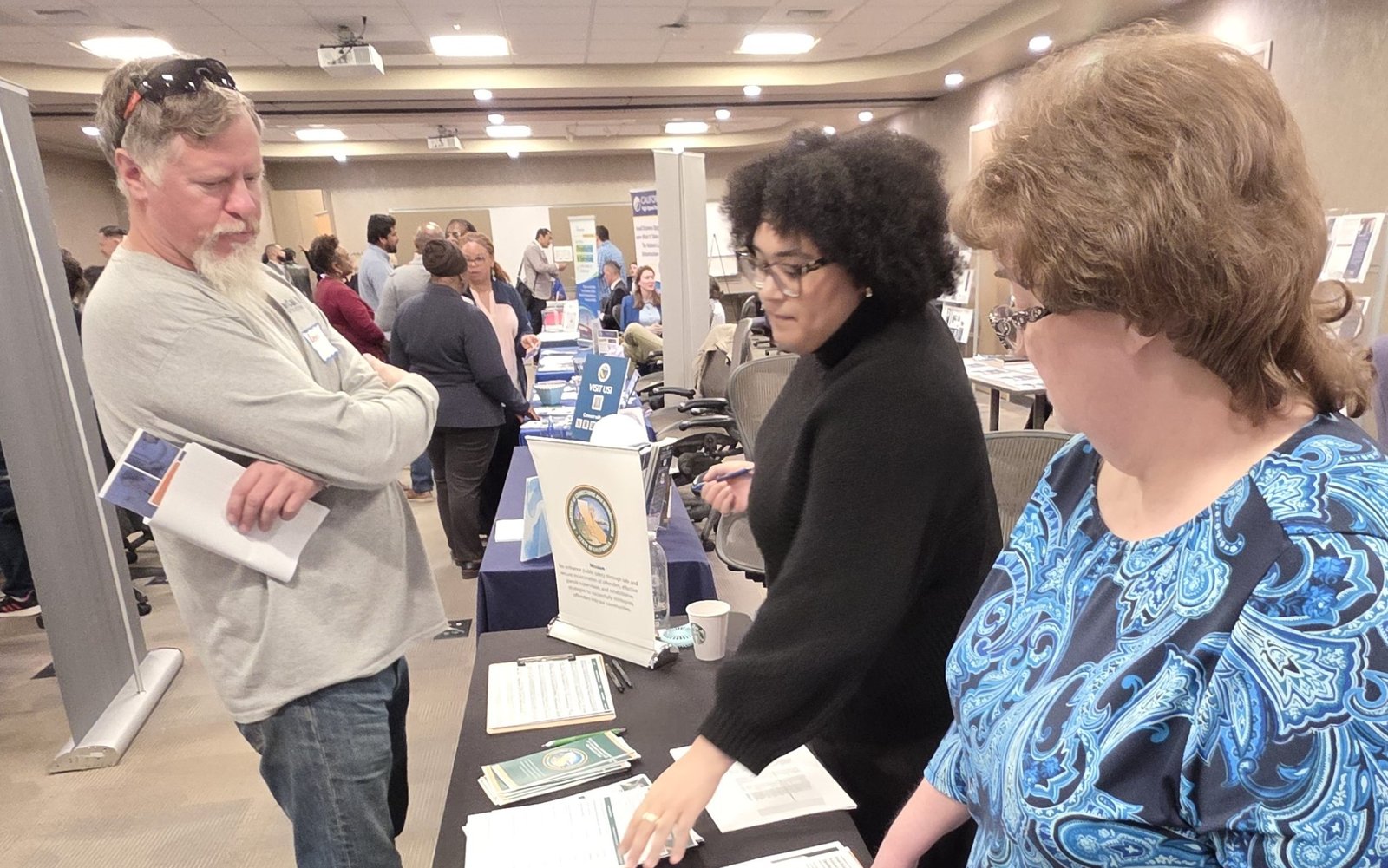 CDCR staff of the Office of Business Services talk to a business owner about contracting with the department.