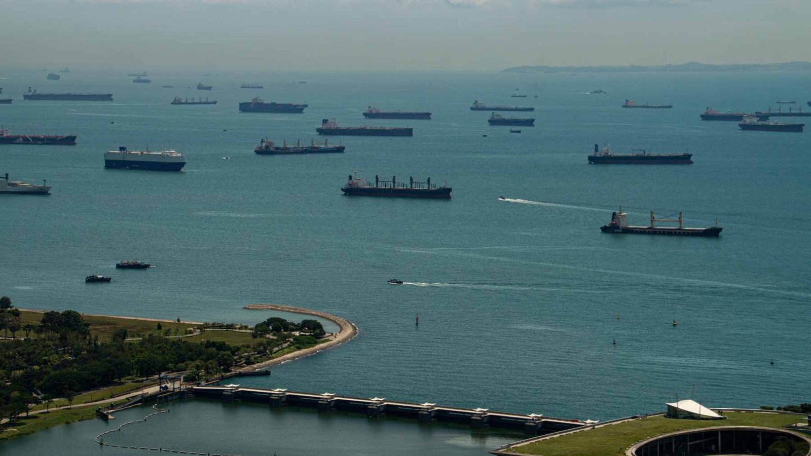 Aerial view of massive oil tankers navigating the narrow, congested waters of the Strait of Hormuz.
