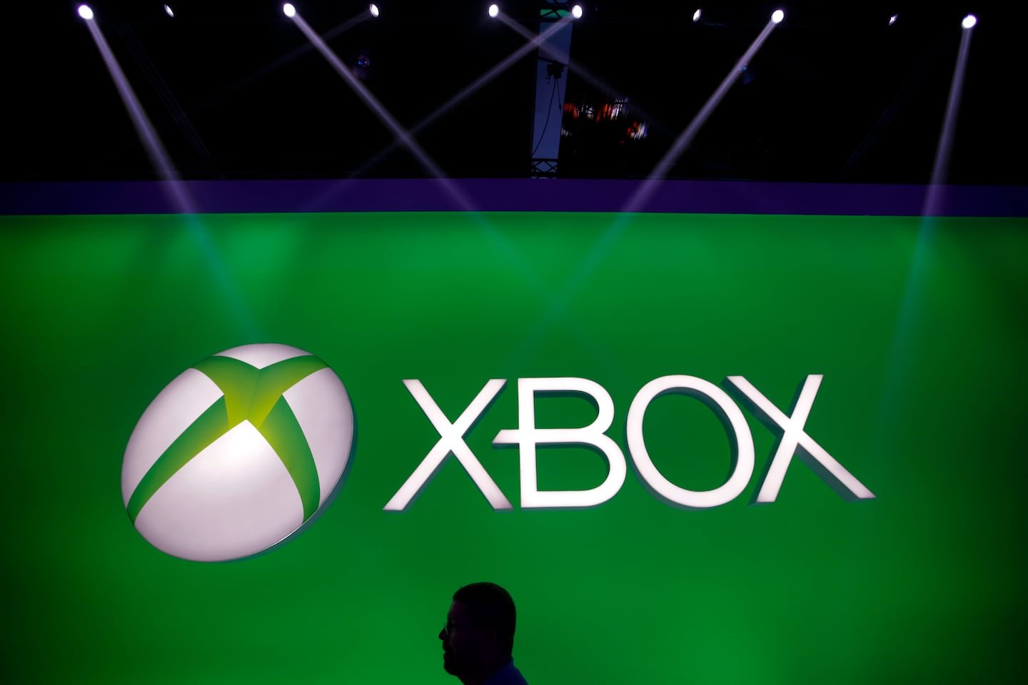 A man walks past the Xbox logo at the Microsoft booth during the E3 game show in Los Angeles.