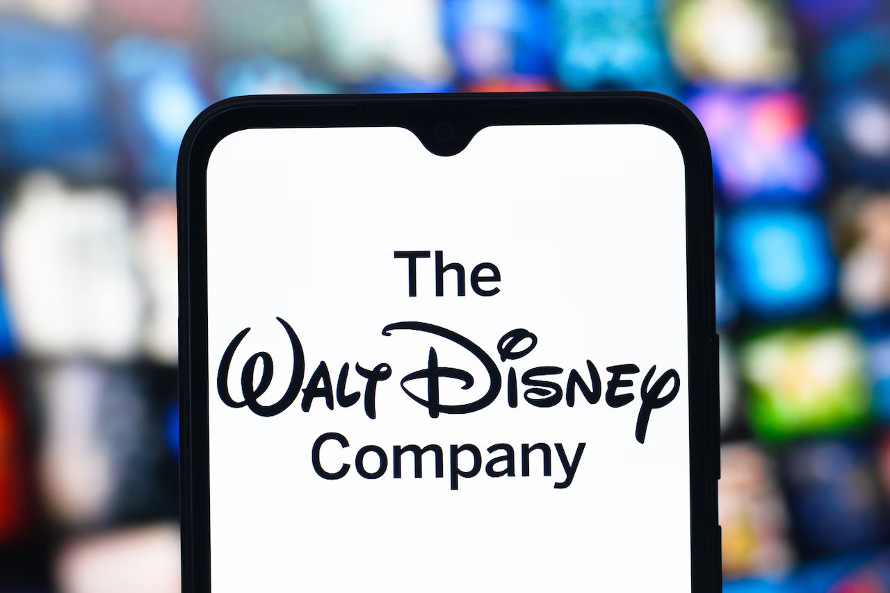In this photo illustration, the Walt Disney Company logo is