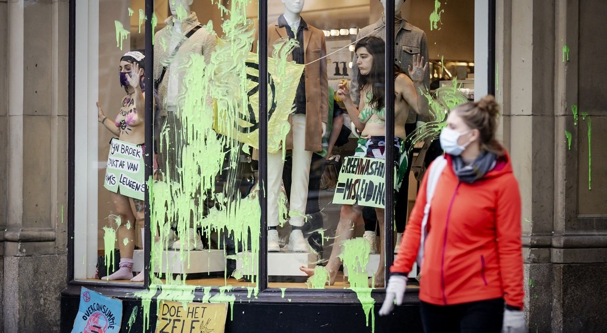 File photo (Extinction Rebellion activists standing in the window of an HM clothes shop in Amsterdam on 29 November 2020 to condemn the companys alleged greenwashing strategy).